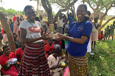Rachel giving out home supplies to a community member in Karamoja.