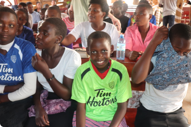 Children at Karugangama Church after receiving clothing gifts from the TUPS team.