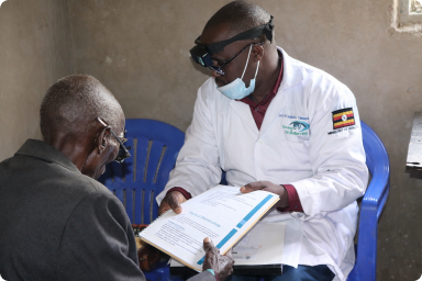 An optician attending to a patient during a health outreach in Rukungiri district.