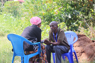 Dan praying for a lady during an outreach in western Uganda.