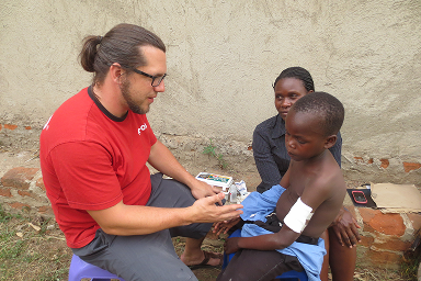 A child receiving a medical check-up during a medical outreach in Central Uganda.