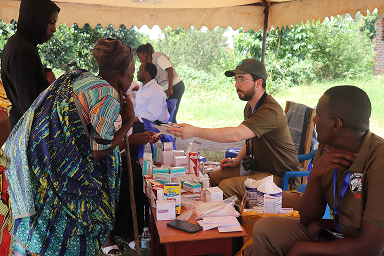 Chris distributing essential medical supplies during an outreach in Rukungiri district.